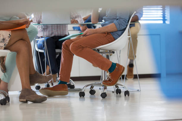 istock Low section of people having meeting in office 525441631