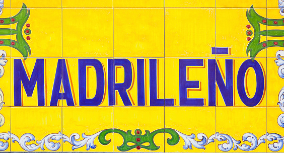 Old painted Spanish tiled sign with Madrileno text, which translates as ‘from Madrid’ and can also be used in reference as to a person from Madrid.