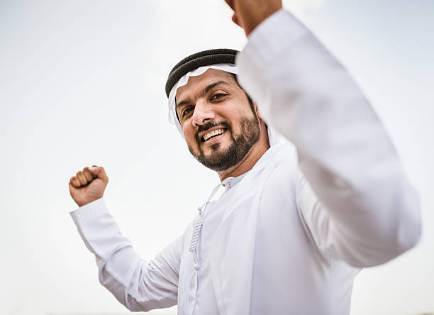 istock arabic sheik portrait laughing on dubai marina 525448639