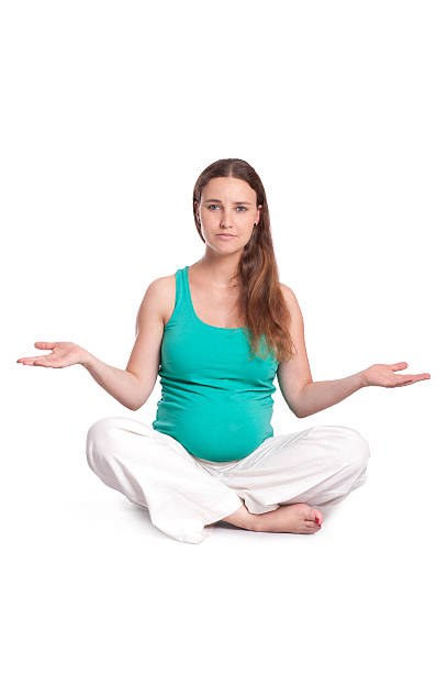 istock Pregnant woman meditating 525448709
