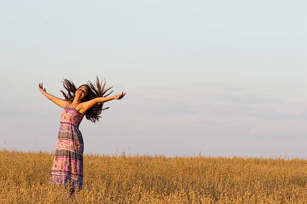 istock The girl is dancing in oat field. 525450547