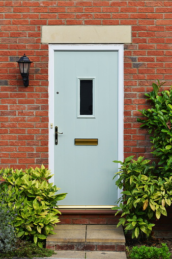 A suspicious senior adult man is staring with one eye from the shadows through the slightly cracked open pocket door between two adjacent rooms. Hang on!! That's not just a nosy neighbor!! He's downright creepy! I think it's a Peeping Tom!! Quick, call the cops!