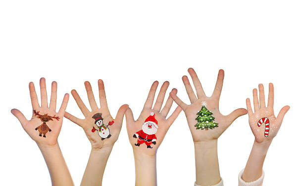 istock Kid's hands with painted Christmas symbols 525451761