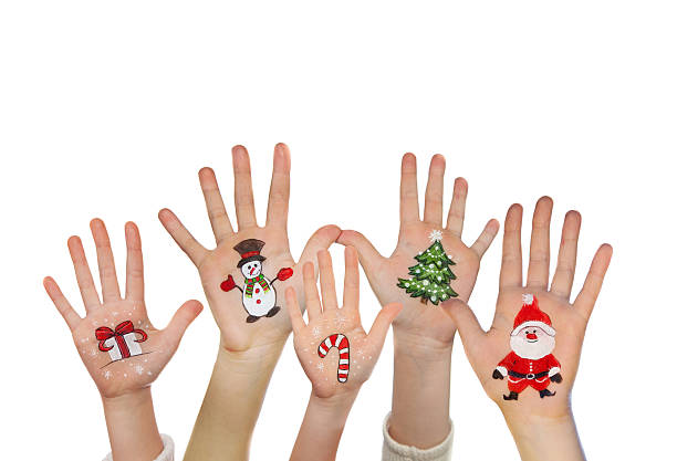 istock Kid's hands with painted Christmas symbols 525451763