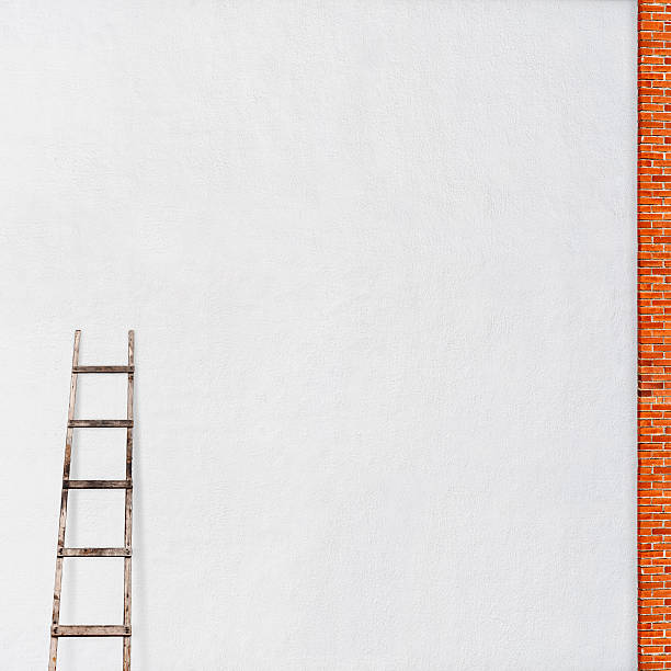 istock weathered brick wall with a wooden ladder 525452881