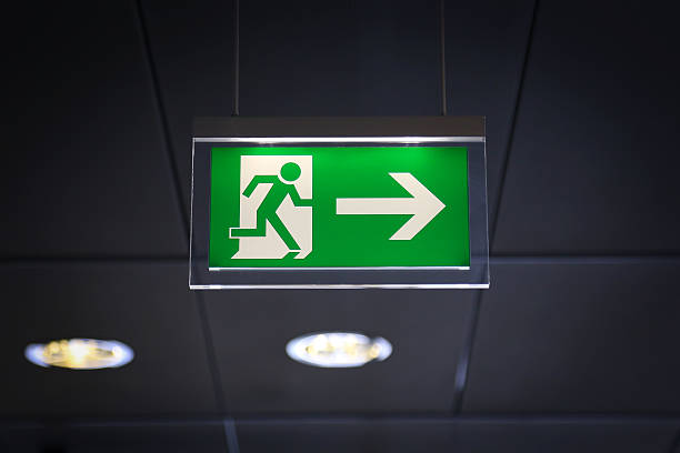 Emergency exit - Stock Image Emergency exit sign above a black doorway exit sign photos stock pictures, royalty-free photos & images
