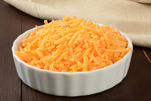 istock Bowl of grated cheddar cheese 525454453