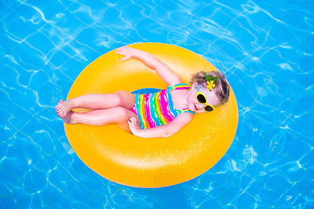istock Little girl in a swimming pool 525454645