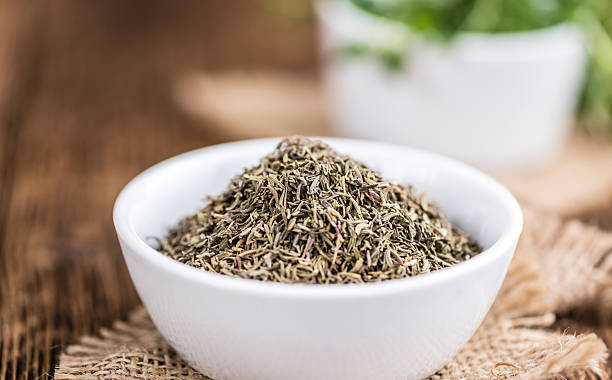 istock Dried Thyme on wooden background 525470256