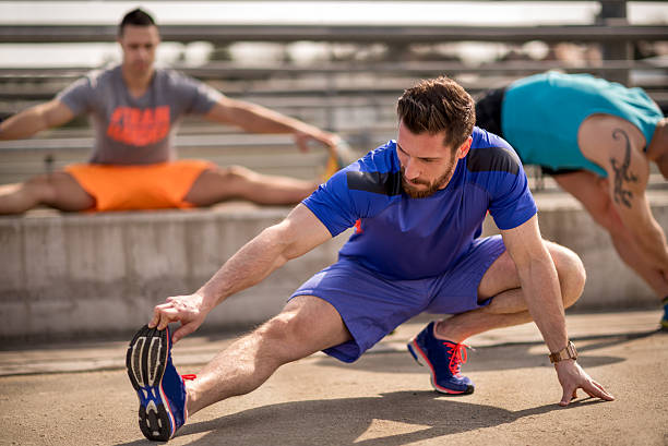 istock Sportsmen stretching out in the open 525471862