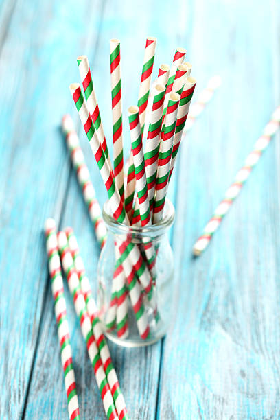 istock Striped drink straws on a blue wooden background 525473138