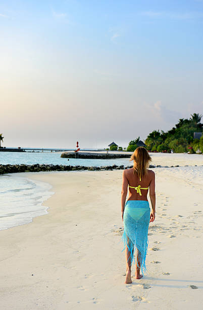 istock Beautiful woman on the beach 525474162