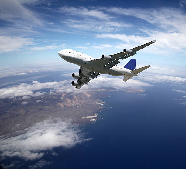 istock Airliner high above ground in the sky 525474968