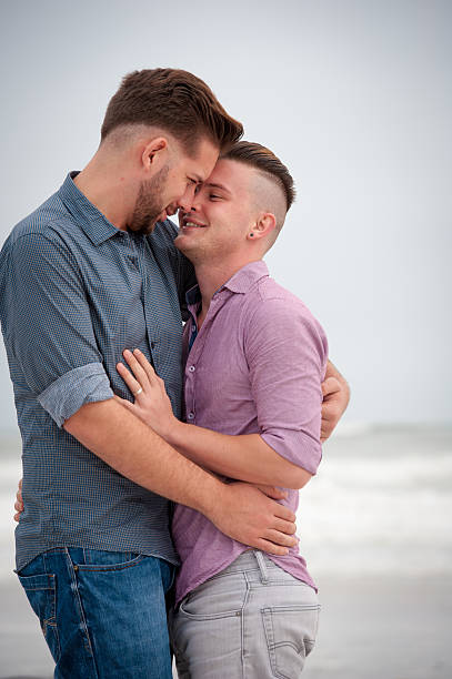 istock Gay men embracing on a beach 525475766