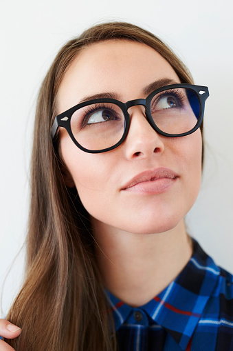 Spectacles on beautiful young woman, looking away