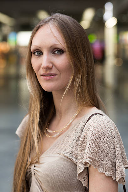 istock Pretty young woman at a passenger train station 525479556