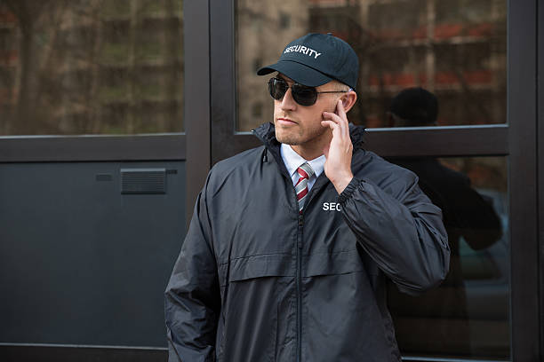 istock Security Guard In Front Of The Door Entrance 525479628