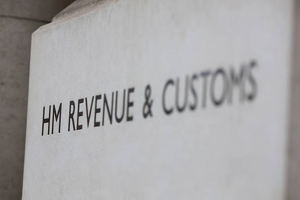 HM revenue and customs sign London, United Kingdom - April 28, 2016: HM Revenue and customs sign outside their offices in Whitehall, London. HMRC is the department of the UK government responsible for the collection of taxes. hm government stock pictures, royalty-free photos & images