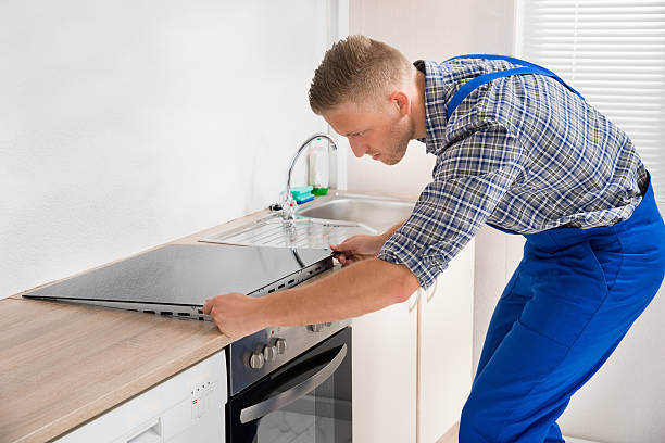 istock Repairman Installing Induction Cooker 525480262