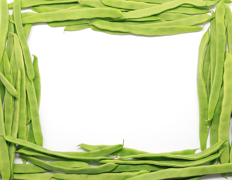 Frame of Green beans on white