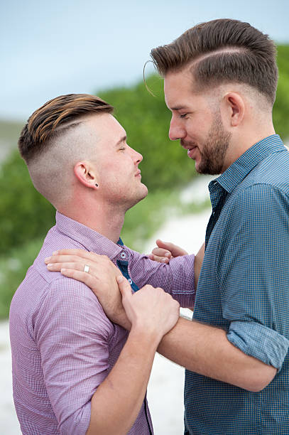 istock Gay men embracing on a fence 525481326