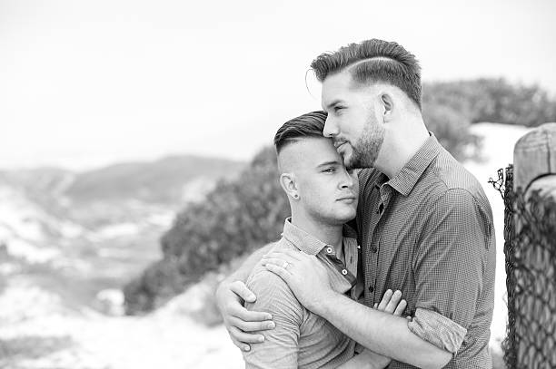 istock Gay men embracing on a fence 525481440