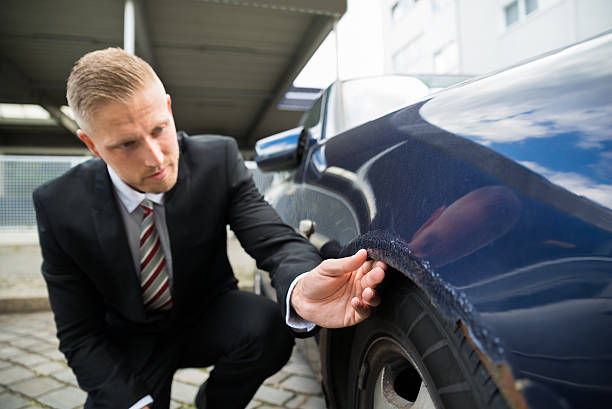 istock Man Looking For Scratches On His Car 525482524