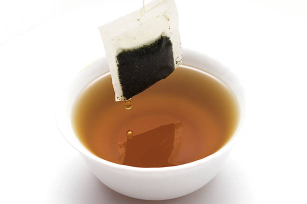 istock Cup of tea with teabag isolated on white background 525483006