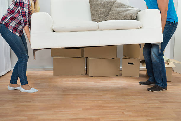 istock Young Couple Carrying Couch 525483782