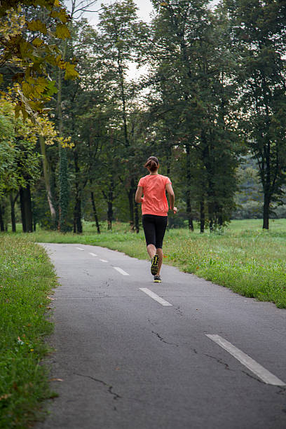 istock Young woman running outdoors 525484672