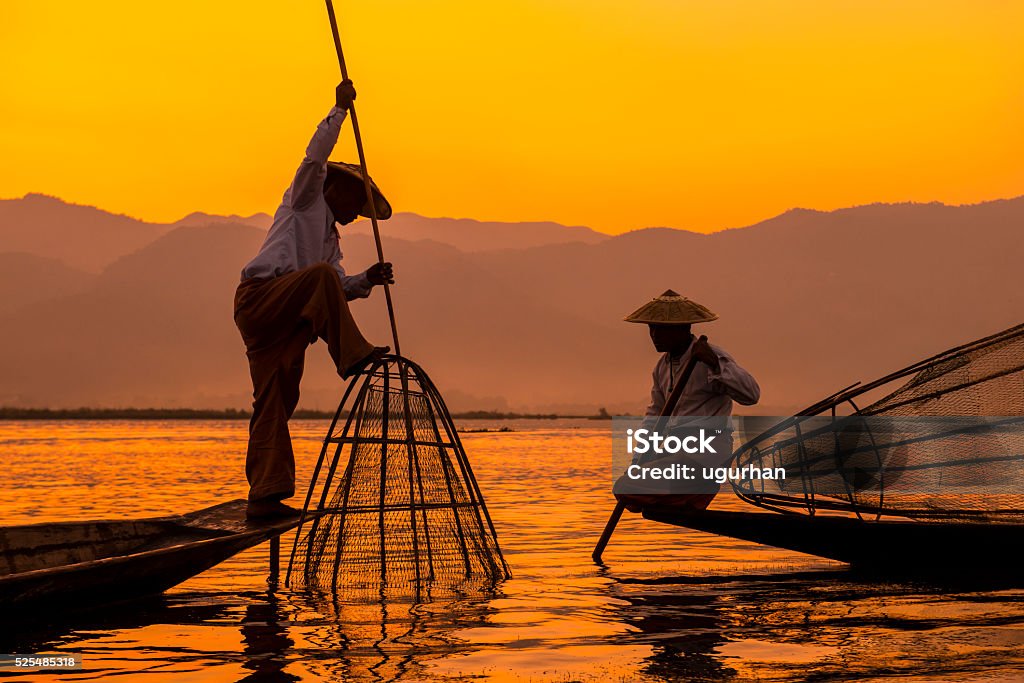 Inle lake Myanmar Fishermen sihouettes at Inle lake on sunset, Myanmar Myanmar Stock Photo