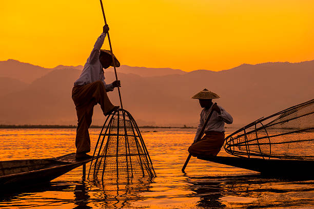 Inle lake Myanmar Fishermen sihouettes at Inle lake on sunset, Myanmar myanmar photos stock pictures, royalty-free photos & images