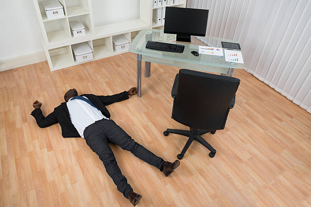istock Unconscious Businessman Lying On Floor 525486846