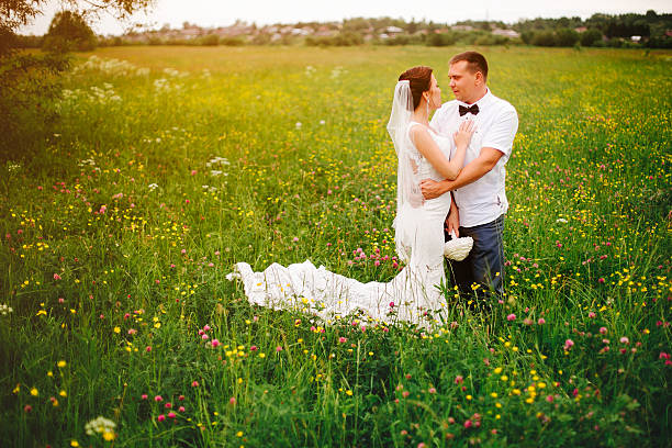 istock Carefree wedding couple on the meadow during sunset 525488282