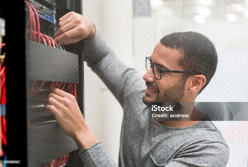 IT technician fixing a server at the office IT technician fixing the server at the office - technology concepts Technology Stock Photo