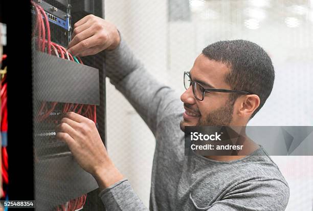 It Technician Fixing A Server At The Office Stock Photo - Download Image Now - Technology, IT Support, Network Server