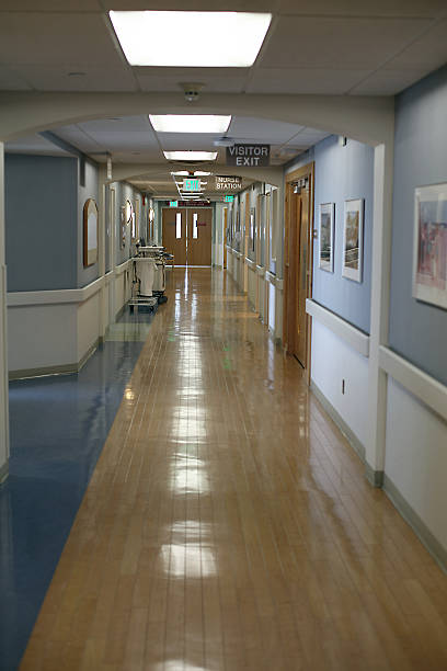 Long, empty hospital corridor.  Closed doors stock photo