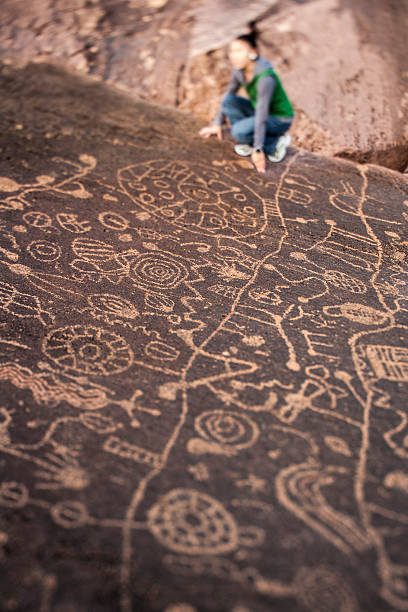 istock Hiker admires native american rock art. 525492996