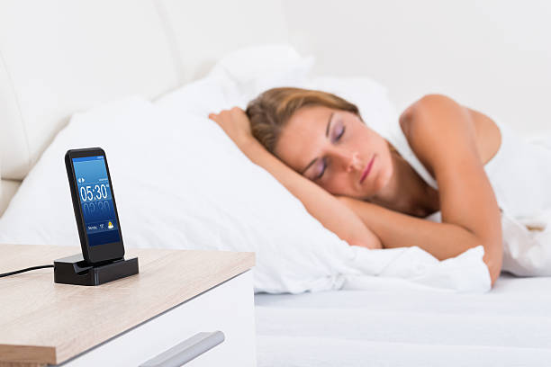 istock Woman Sleeping With Alarm On Mobile Phone 525493244