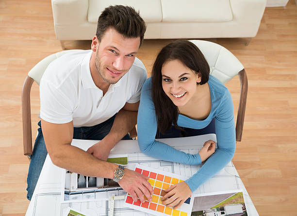istock Young Couple Choosing Color From Swatch 525495876