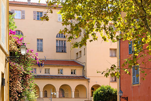 istock Flowered Courtyard among Elegant Buildings 525496003