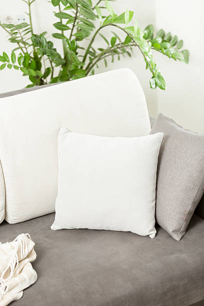 istock white decorative cushion lying on gray sofa at living room 525496922