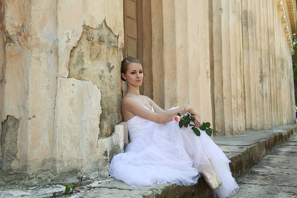 istock Beautiful ballerina in ancient colonnade 525497249