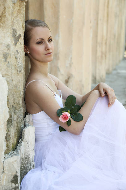 istock Beautiful ballerina in ancient colonnade 525497269