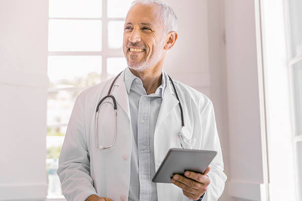 istock Happy doctor holding digital tablet in clinic 525497746