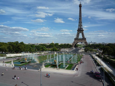 Eiffel Tower during daytime with blue, cloudy sky
