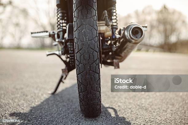 Wheel And Exhaust Pipe Of Motorcycle On Road Stock Photo - Download Image Now - Motorcycle, Exhaust Pipe, Tire - Vehicle Part