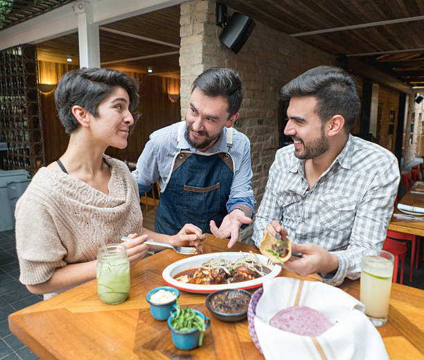 istock Waiter serving couple at a restaurant 525498428