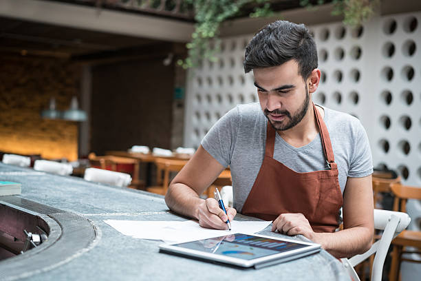 Business man doing the books at a restaurant