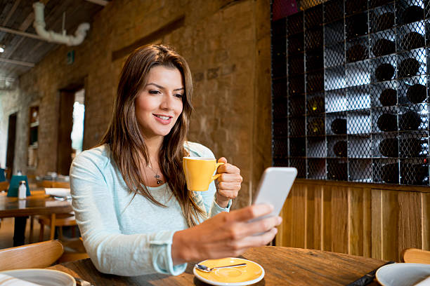 istock Woman texting at a cafe 525498612
